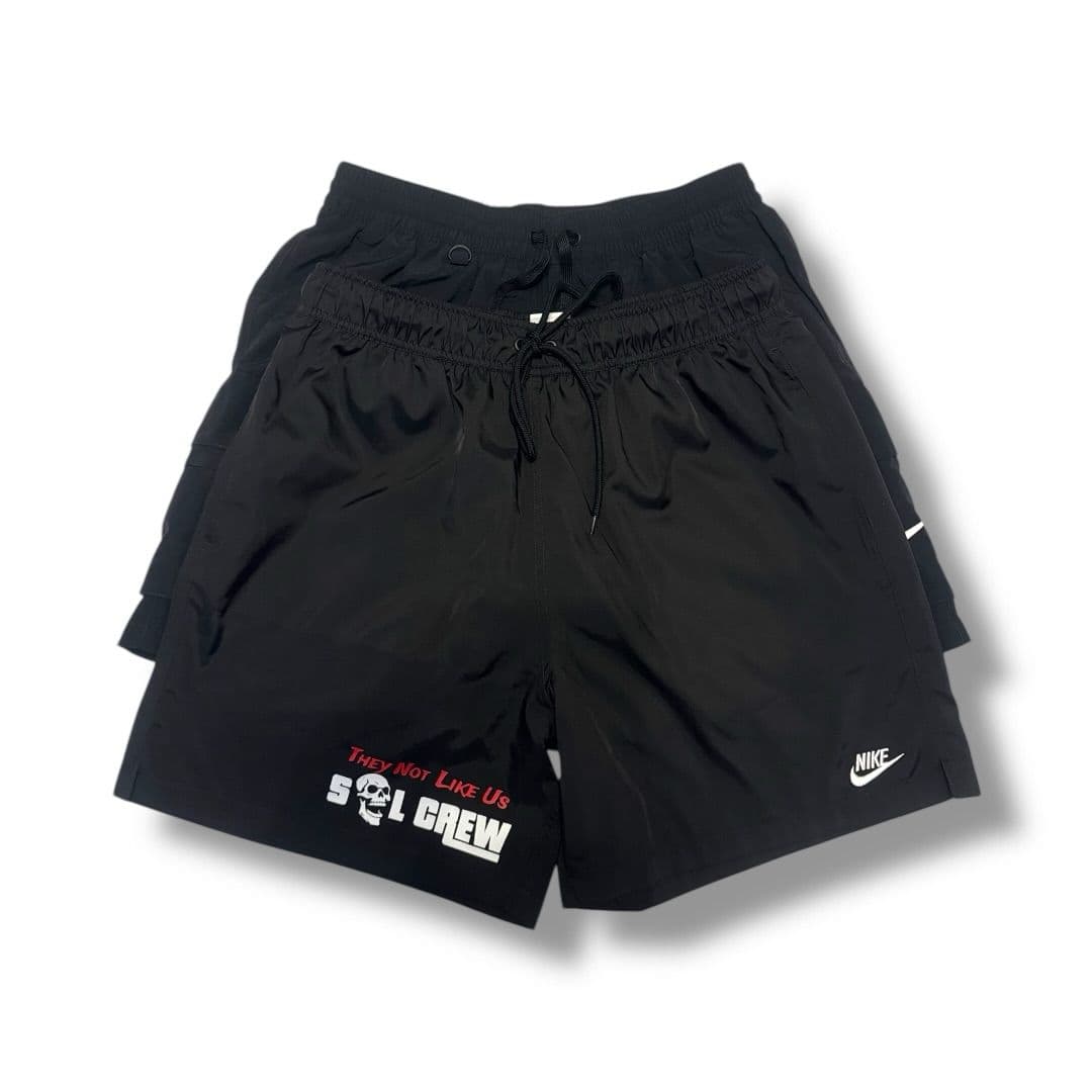 Black athletic shorts with a printed logo on the leg