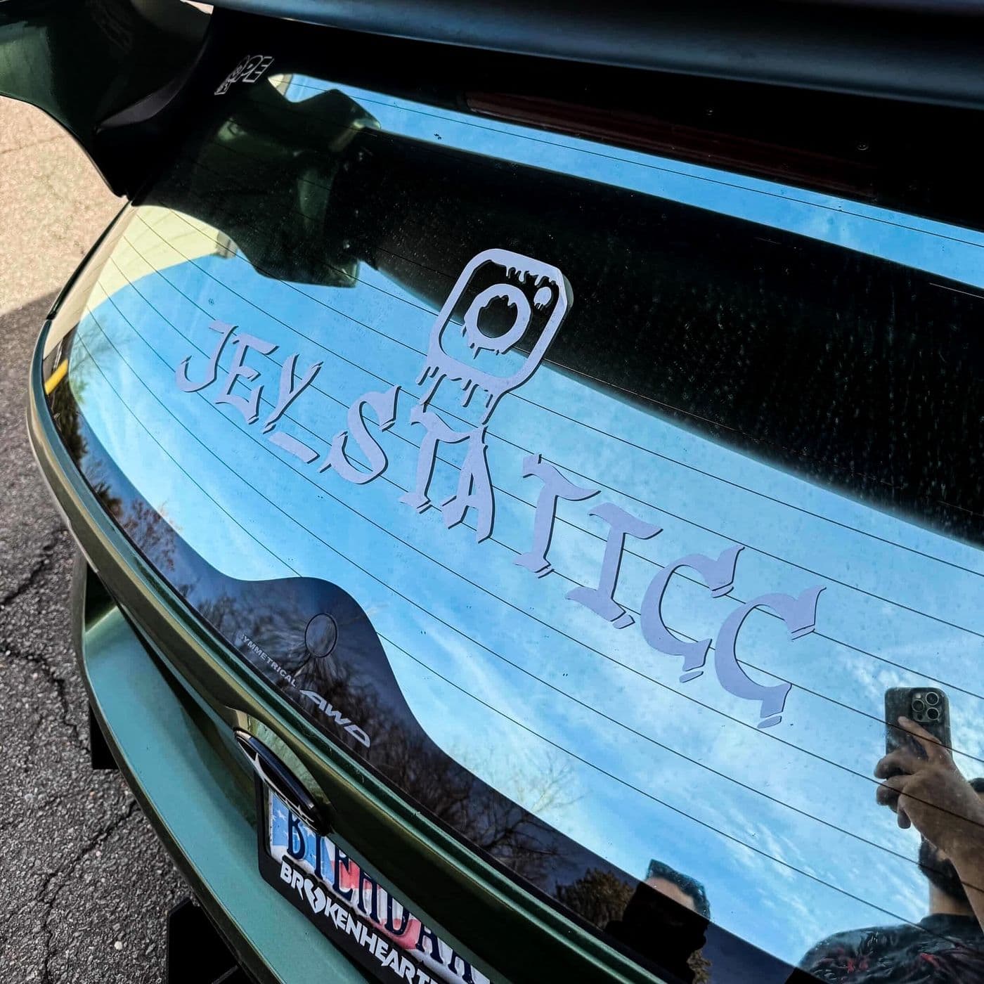 Instagram logo and handle sticker on a car’s rear windshield